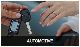 Locksmith handing reprogrammed car remote to customer.